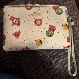 Coach Cream Colored Wristlet with Festive Print.  Excellent condition. Used once